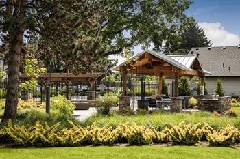 Covered outdoor pavilion with stone columns and dining area